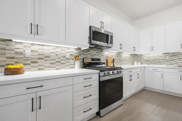 kitchen featuring sink, backsplash, white cabinets, and stainless steel appliances