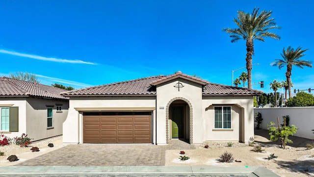 mediterranean / spanish-style house featuring a garage