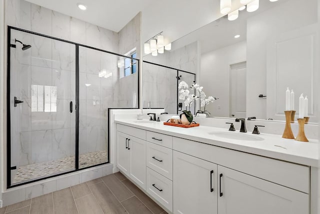 bathroom with vanity and a shower with door