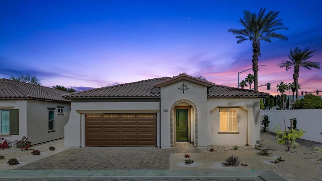 mediterranean / spanish house featuring a garage