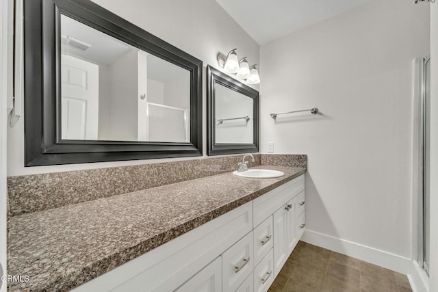 bathroom with vanity, a shower with shower door, and tile patterned flooring