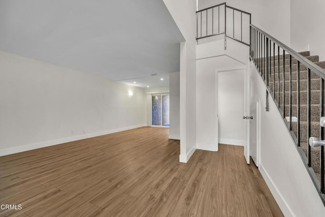 stairway featuring wood-type flooring