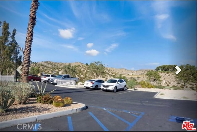 view of parking with a mountain view