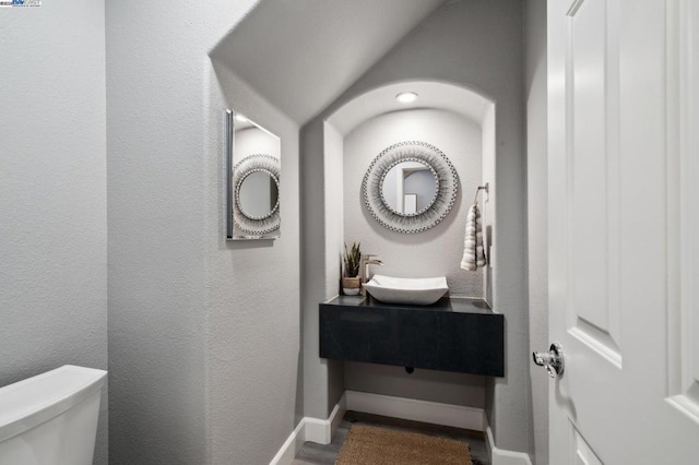 bathroom featuring toilet and vanity