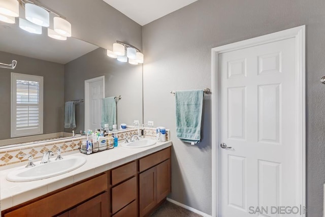 bathroom with decorative backsplash and vanity