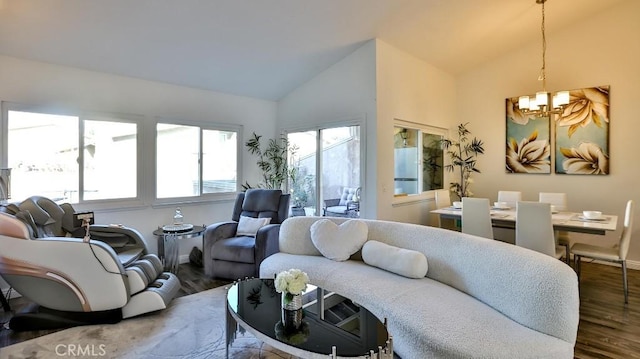 living room featuring hardwood / wood-style floors, lofted ceiling, and a chandelier