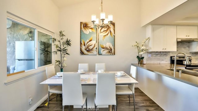 dining room with an inviting chandelier and dark hardwood / wood-style floors