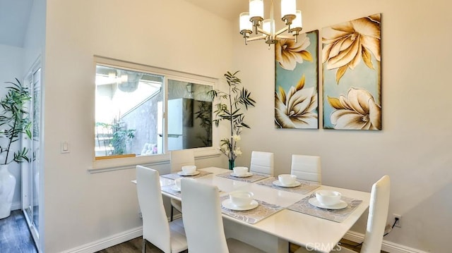 dining space featuring an inviting chandelier and dark hardwood / wood-style floors