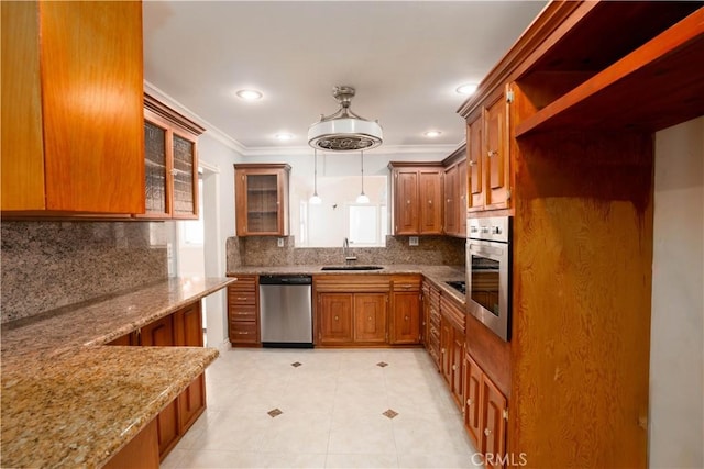 kitchen featuring light stone countertops, a wealth of natural light, stainless steel appliances, and pendant lighting