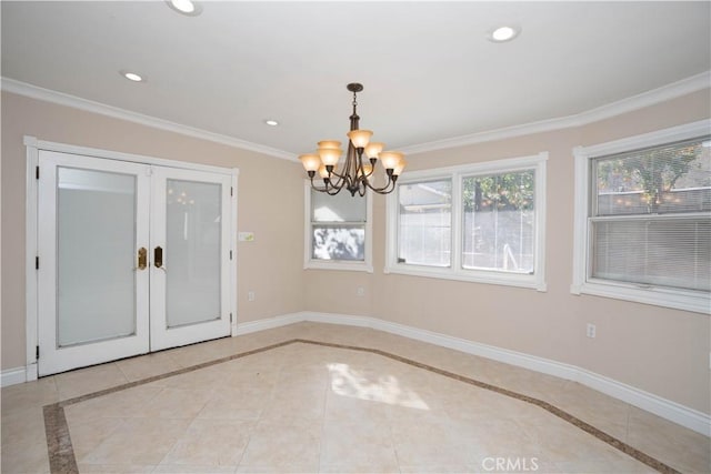 unfurnished dining area with crown molding, french doors, and an inviting chandelier