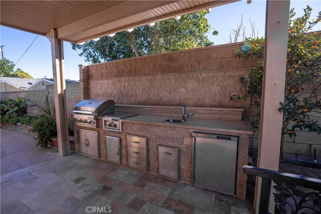 view of patio featuring an outdoor kitchen, sink, and a grill