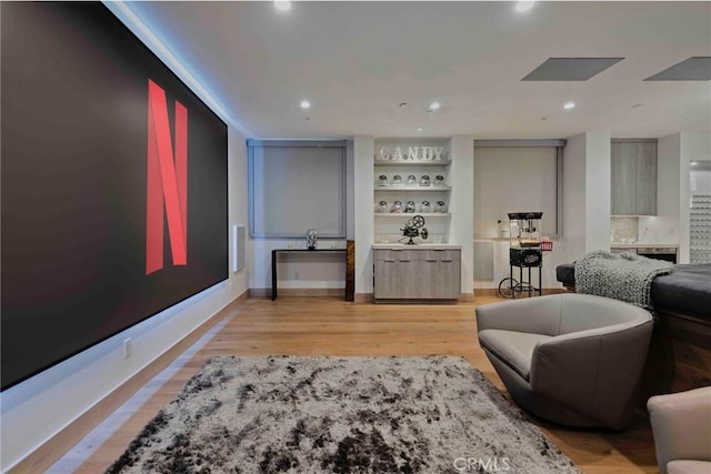 living area featuring light wood-type flooring and bar area