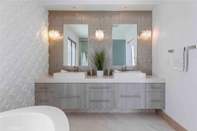 bathroom with vanity, a tub, and tile walls