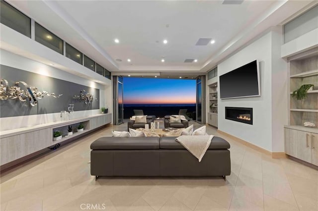 home theater room featuring light tile patterned floors and built in shelves