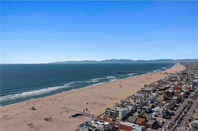 view of water feature with a beach view and a mountain view