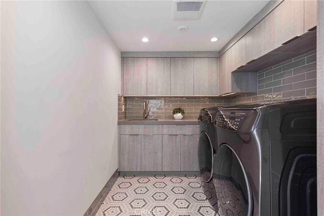 washroom featuring washer and dryer and sink