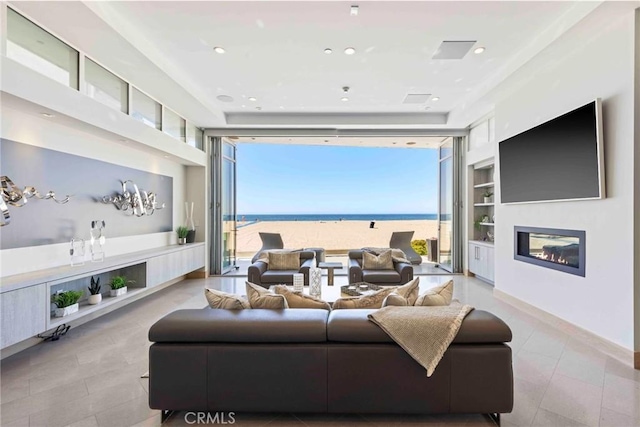 living room featuring built in features and floor to ceiling windows