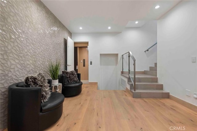 interior space with elevator and light wood-type flooring