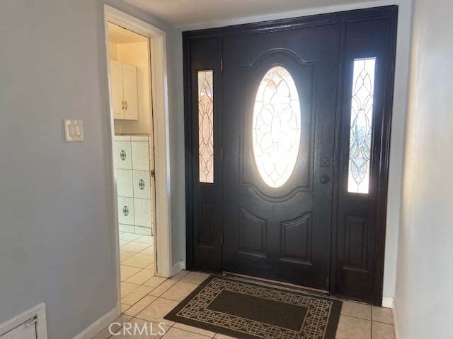 tiled entryway with a wealth of natural light