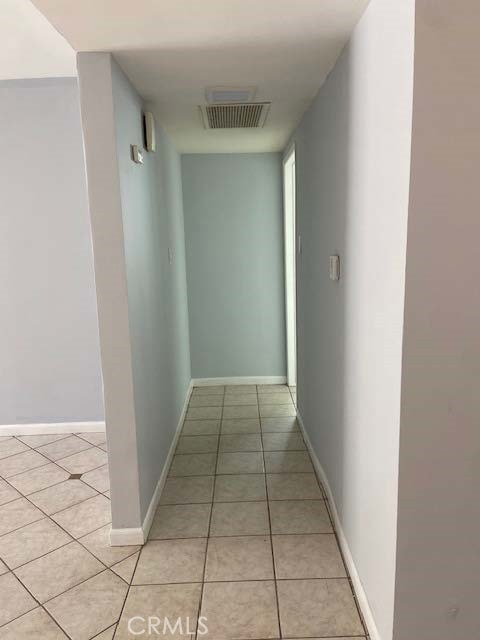 corridor featuring light tile patterned floors