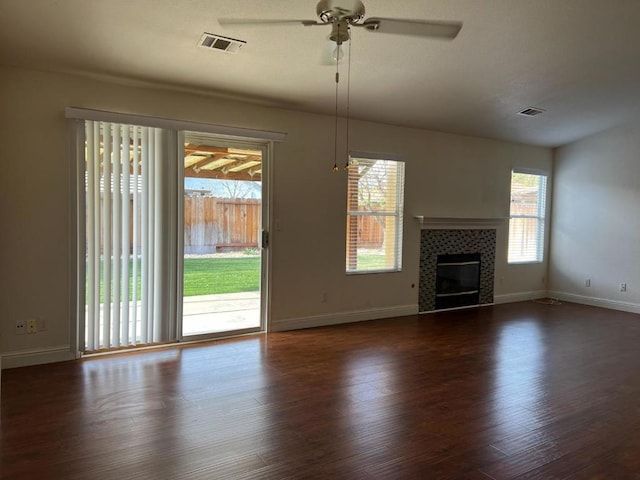 unfurnished living room with dark hardwood / wood-style floors, ceiling fan, and a fireplace