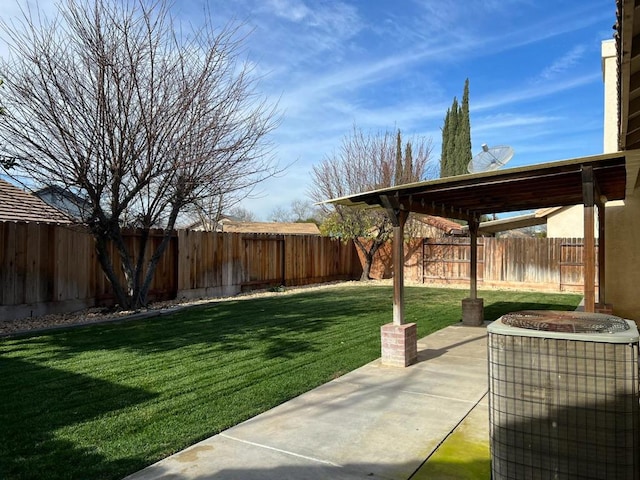 view of yard featuring a patio and central AC