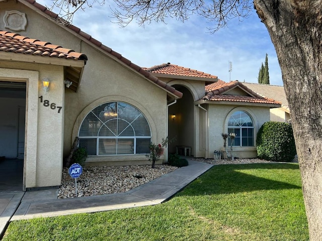 doorway to property featuring a yard