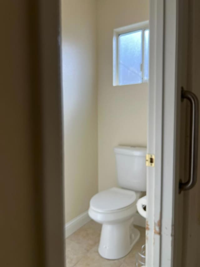 bathroom with tile patterned floors and toilet