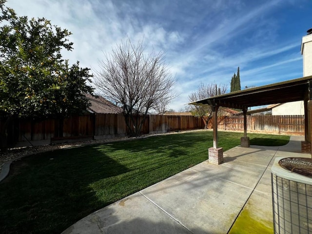 view of yard with cooling unit and a patio area