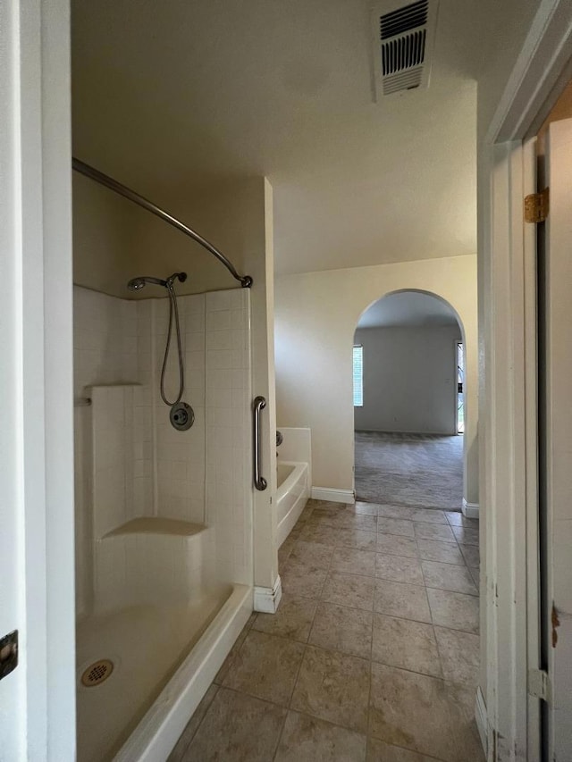 bathroom with tile patterned flooring and independent shower and bath