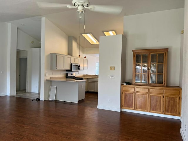 kitchen with pendant lighting, stainless steel appliances, kitchen peninsula, and dark wood-type flooring