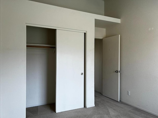 unfurnished bedroom with carpet floors and a closet