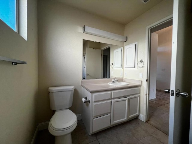 bathroom featuring vanity, tile patterned flooring, and toilet