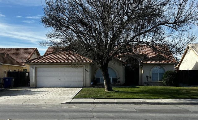 mediterranean / spanish home with a garage and a front yard