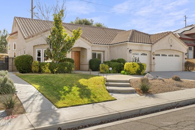 view of front of property featuring a front yard and a garage