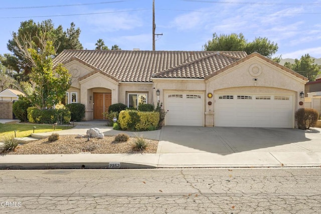 mediterranean / spanish house with a garage