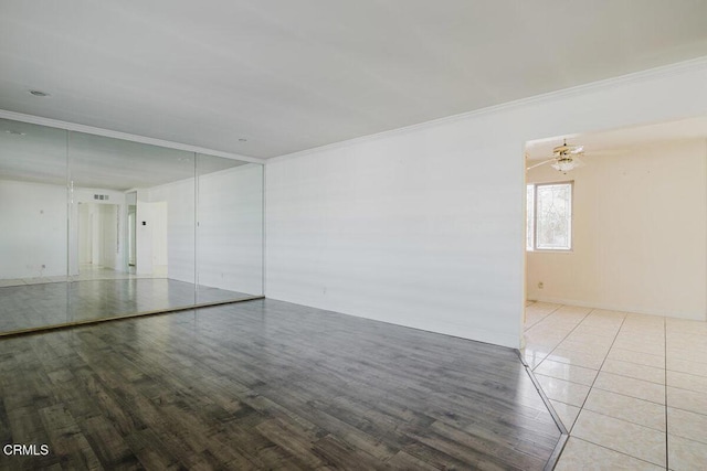 unfurnished room with ceiling fan, hardwood / wood-style floors, and crown molding