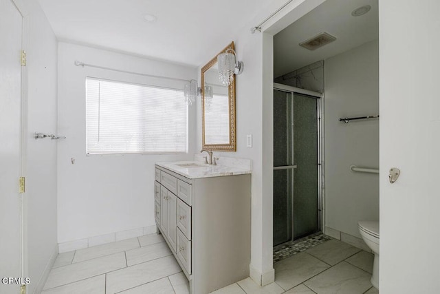 bathroom featuring toilet, tile patterned flooring, an enclosed shower, and vanity