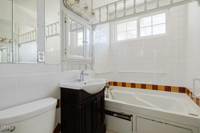 bathroom featuring vanity, decorative backsplash, tile walls, toilet, and a tub to relax in