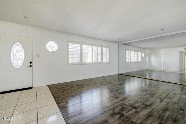 tiled entrance foyer with crown molding