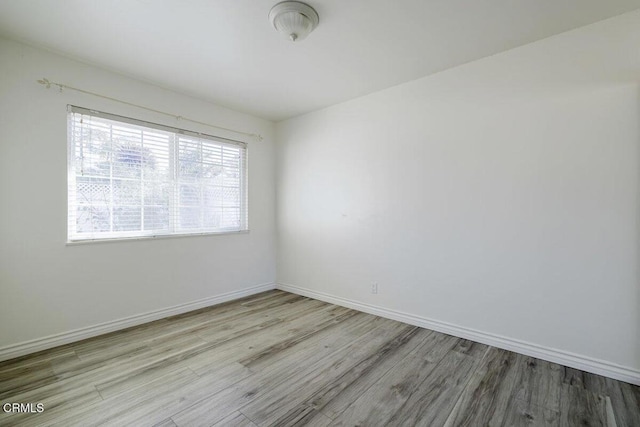 spare room featuring light hardwood / wood-style flooring