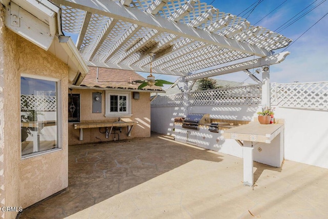 view of patio with an outdoor kitchen, grilling area, and a pergola