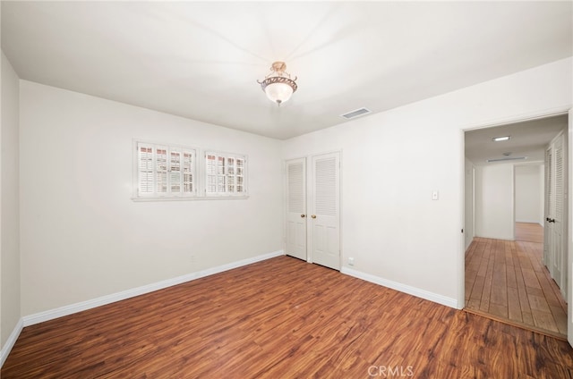 empty room with hardwood / wood-style floors