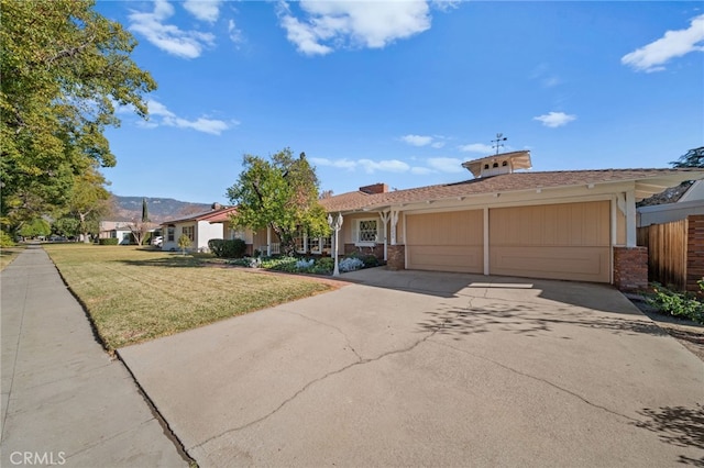 ranch-style home with a front lawn and a garage