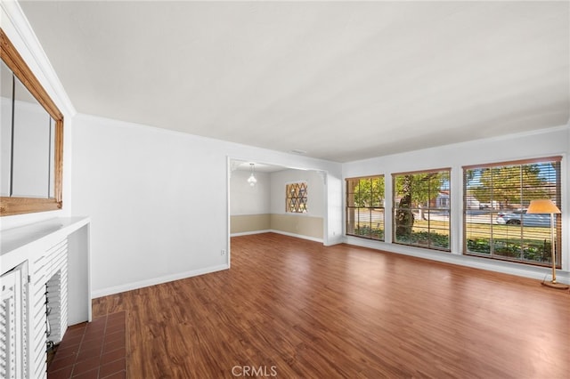 unfurnished living room featuring a healthy amount of sunlight, a fireplace, and hardwood / wood-style floors