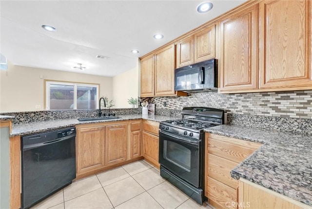 kitchen featuring black appliances, sink, dark stone countertops, and tasteful backsplash