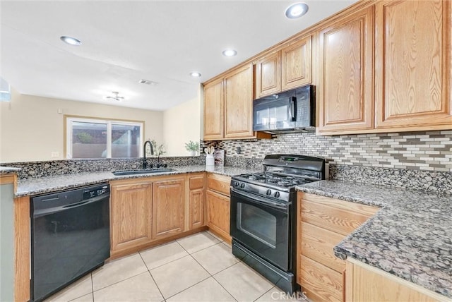 kitchen featuring decorative backsplash, sink, dark stone countertops, and black appliances