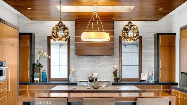 kitchen with stove, oven, wooden ceiling, and decorative backsplash