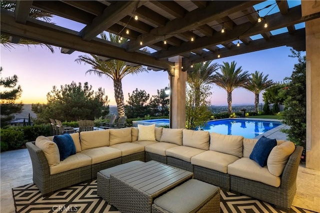 patio terrace at dusk with an outdoor pool, a pergola, and an outdoor living space