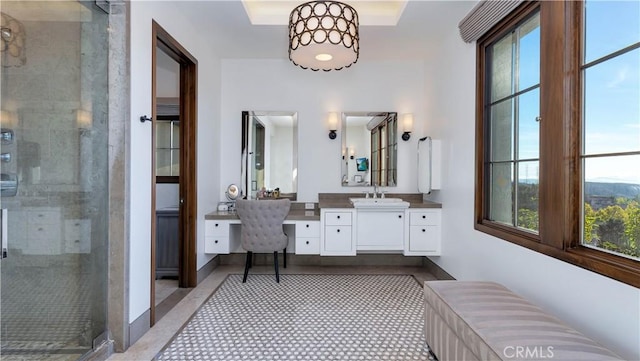 bathroom with a shower stall, a wealth of natural light, and vanity